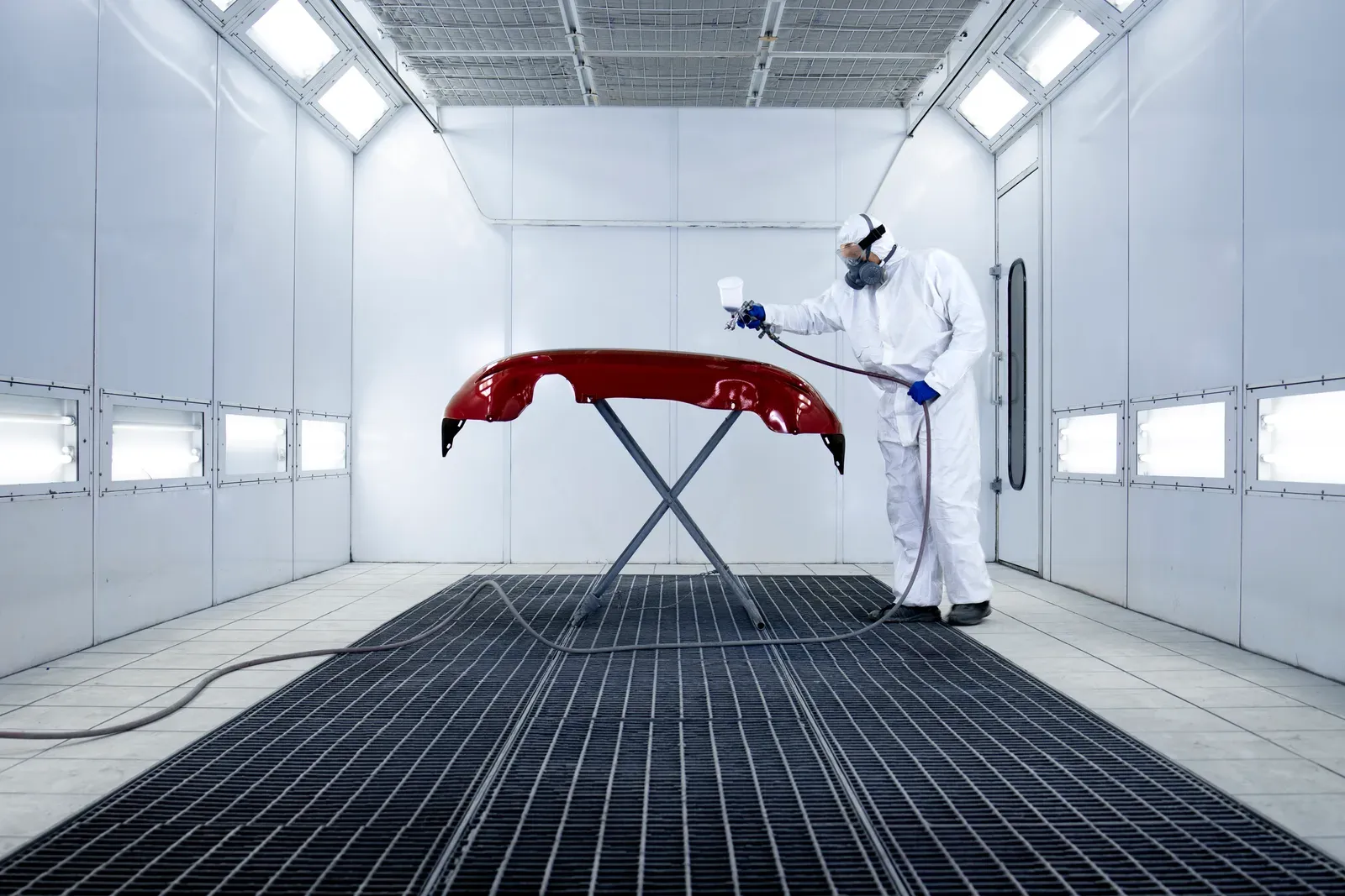 A vehicle inside the downdraft spray booth