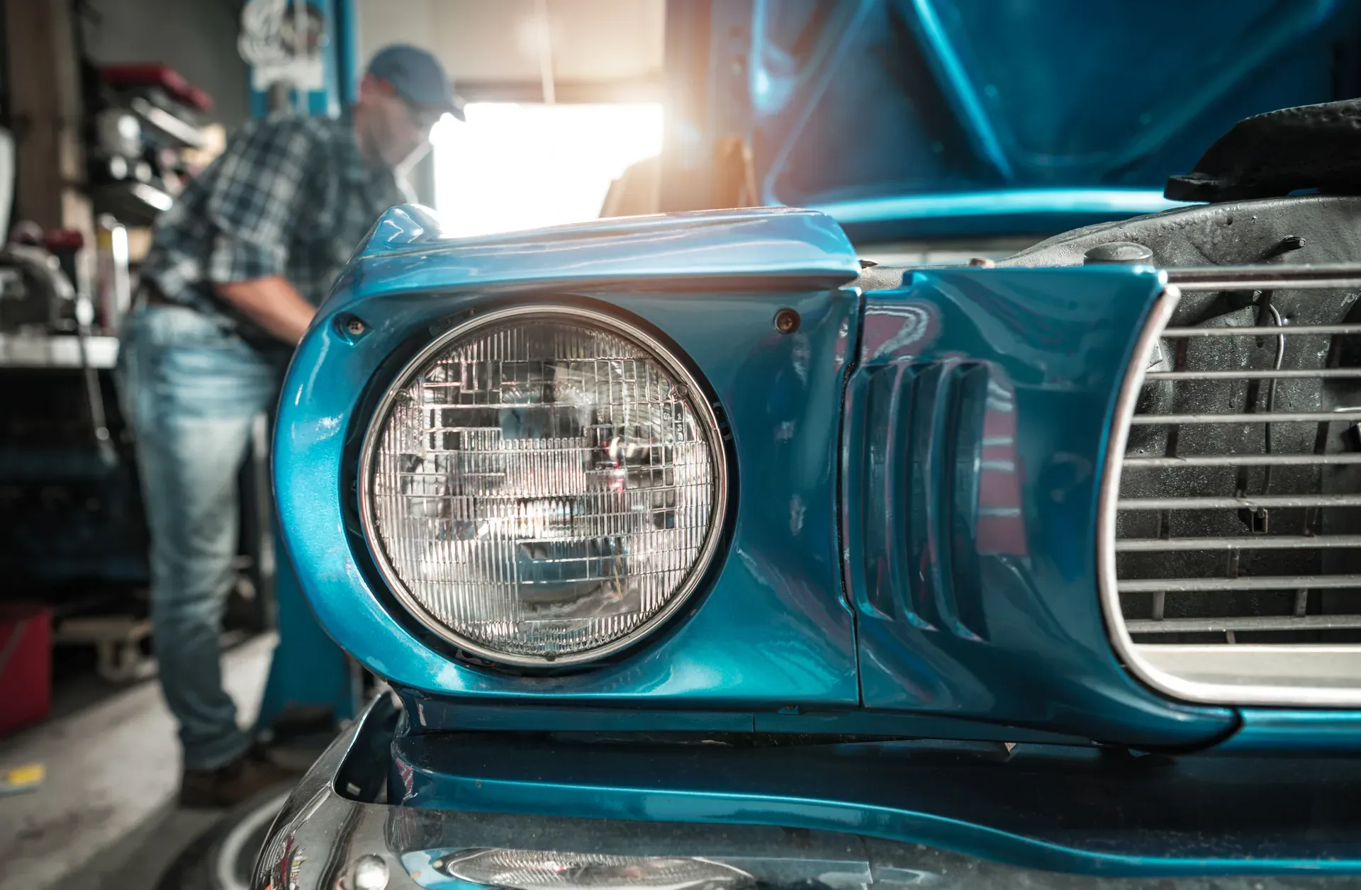 A technician carefully working on a car body panel