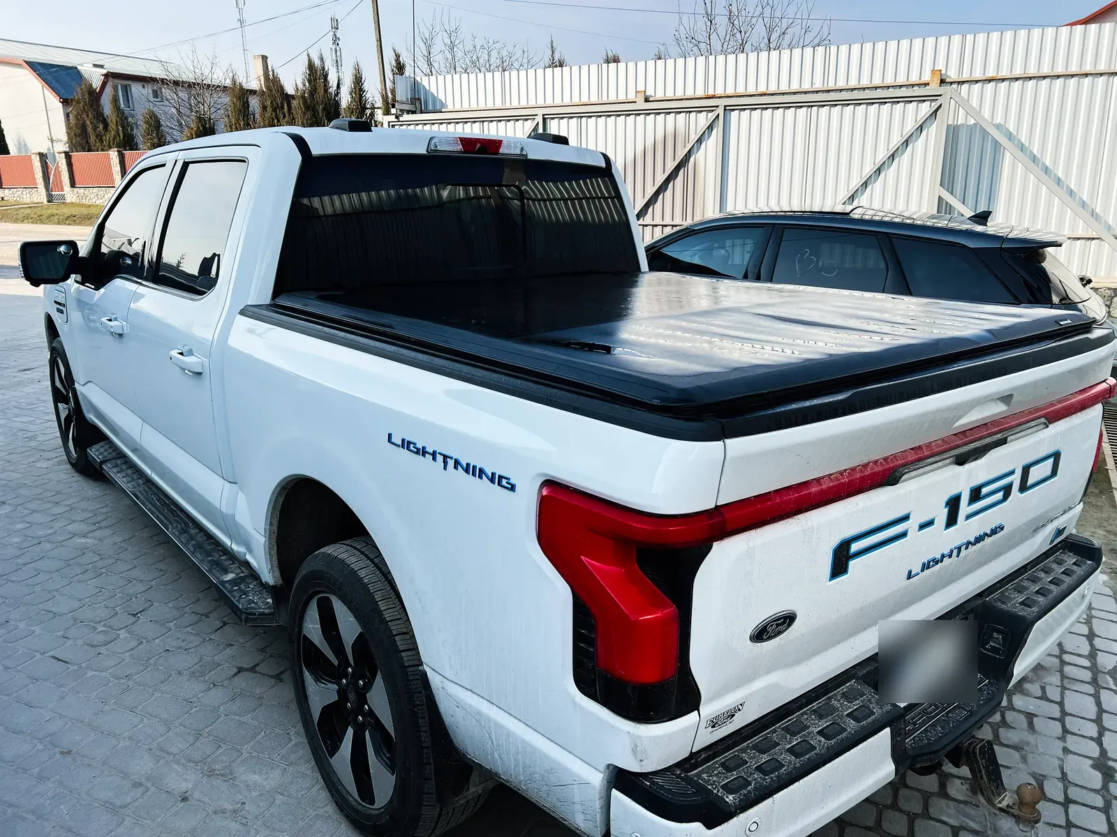 Pickup truck bed and tailgate being inspected for dent damage at a North York body shop