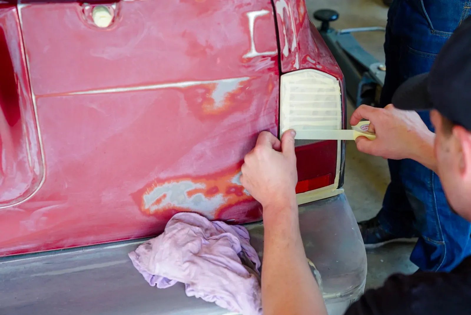 Technician sanding and prepping a vehicle panel for paint at Collision Auto Center in North York