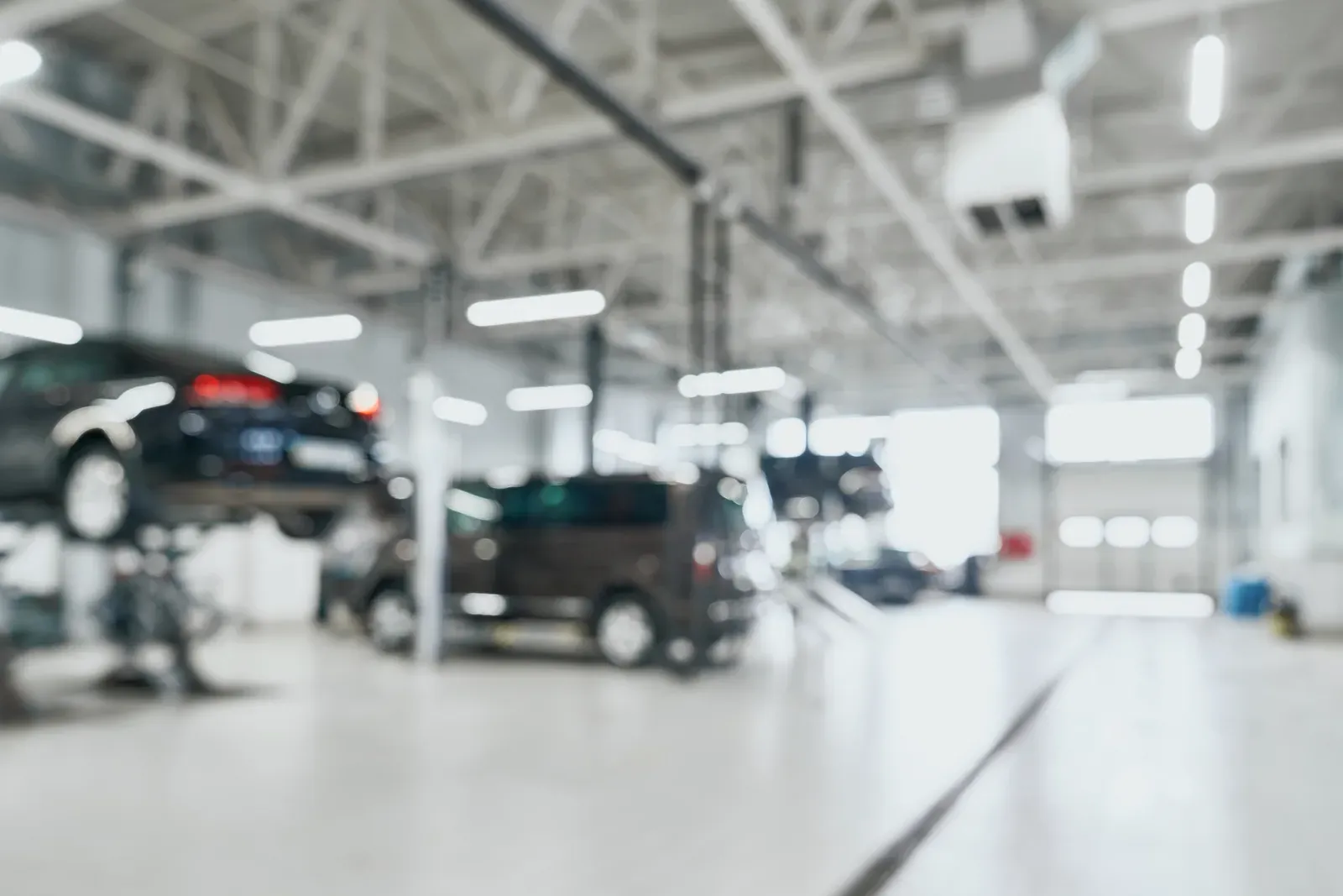 Technician working on a vehicle in a service bay at Collision Auto Center in North York