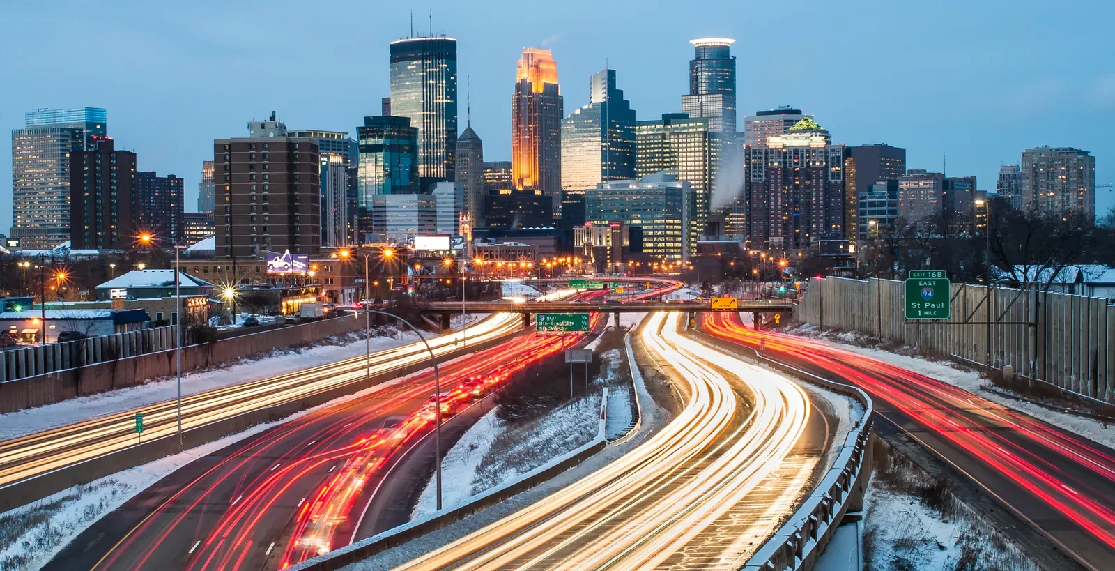 Traffic moving along a snowy GTA highway in winter